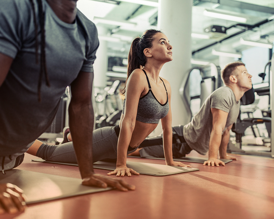 3 people are doing yoga